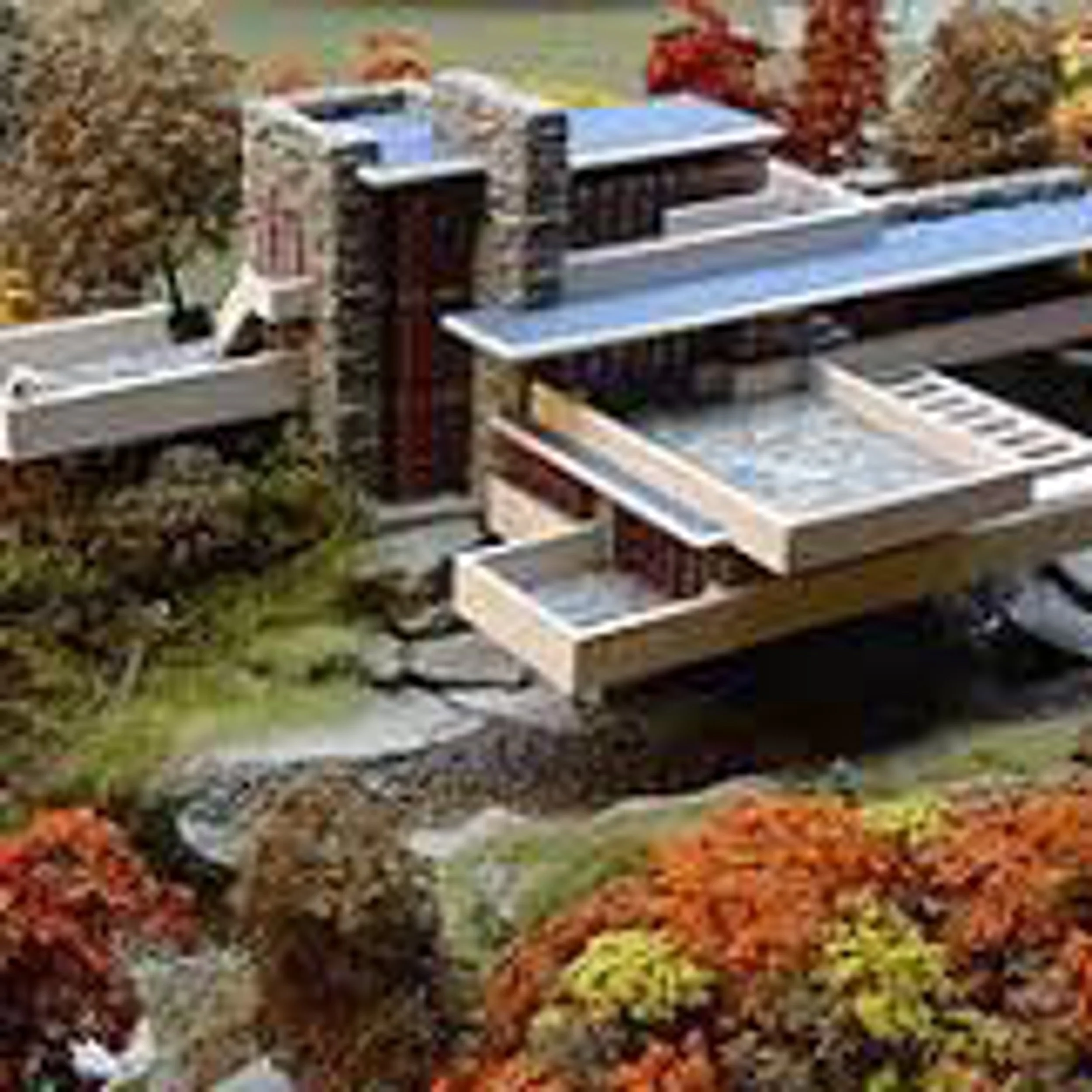 Detailed physical architectural model of a cantilevered modernist house over a stream, surrounded by autumn foliage.