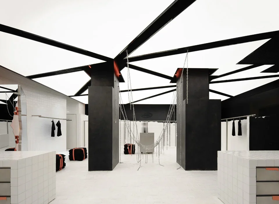 Interior of PMW Hangzhou retail store featuring a luminous geometric ceiling grid and hanging metal chains by All Design Studio.