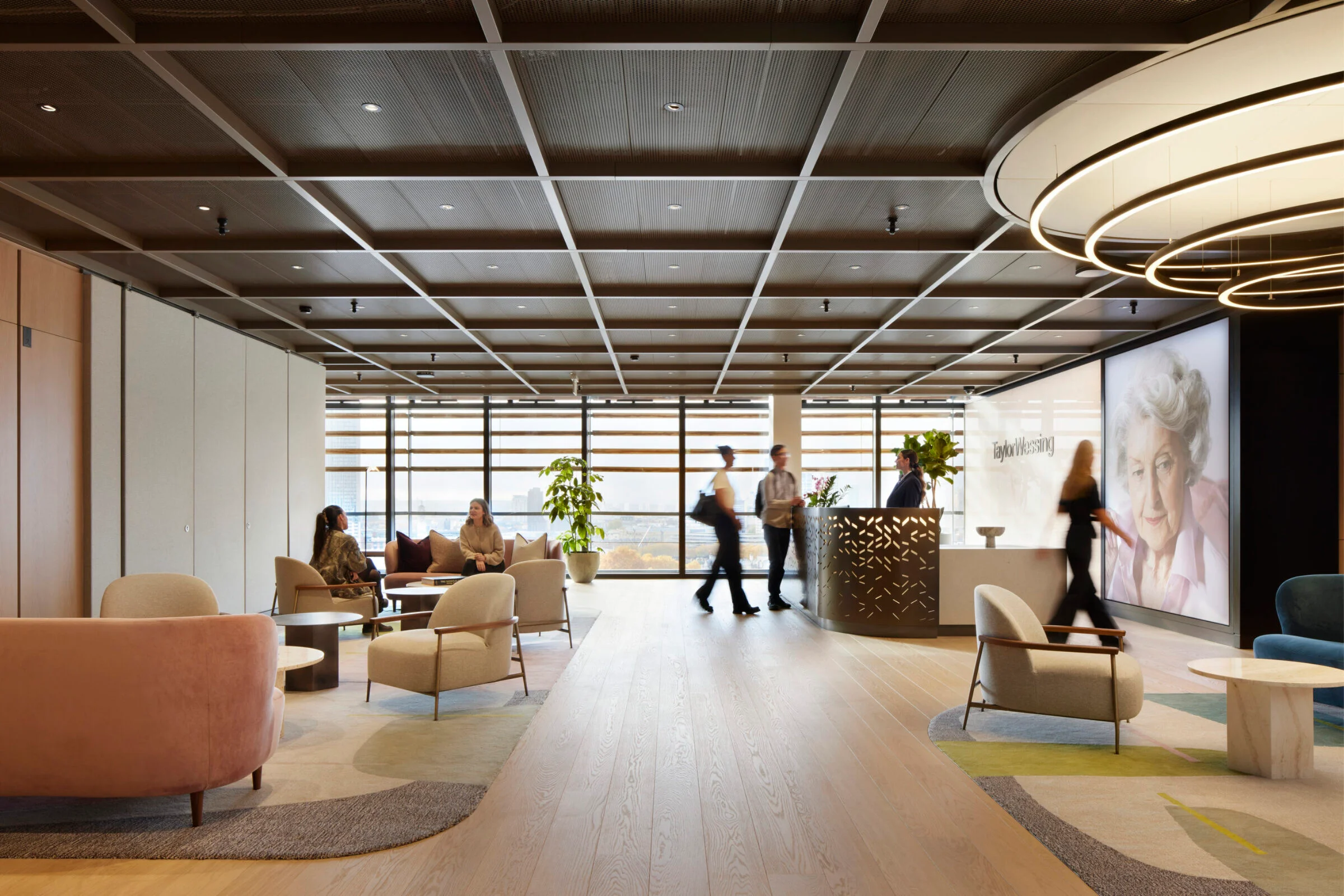Corporate reception and lounge interior with timber flooring, a gridded ceiling, and custom furniture by The Furniture Practice.