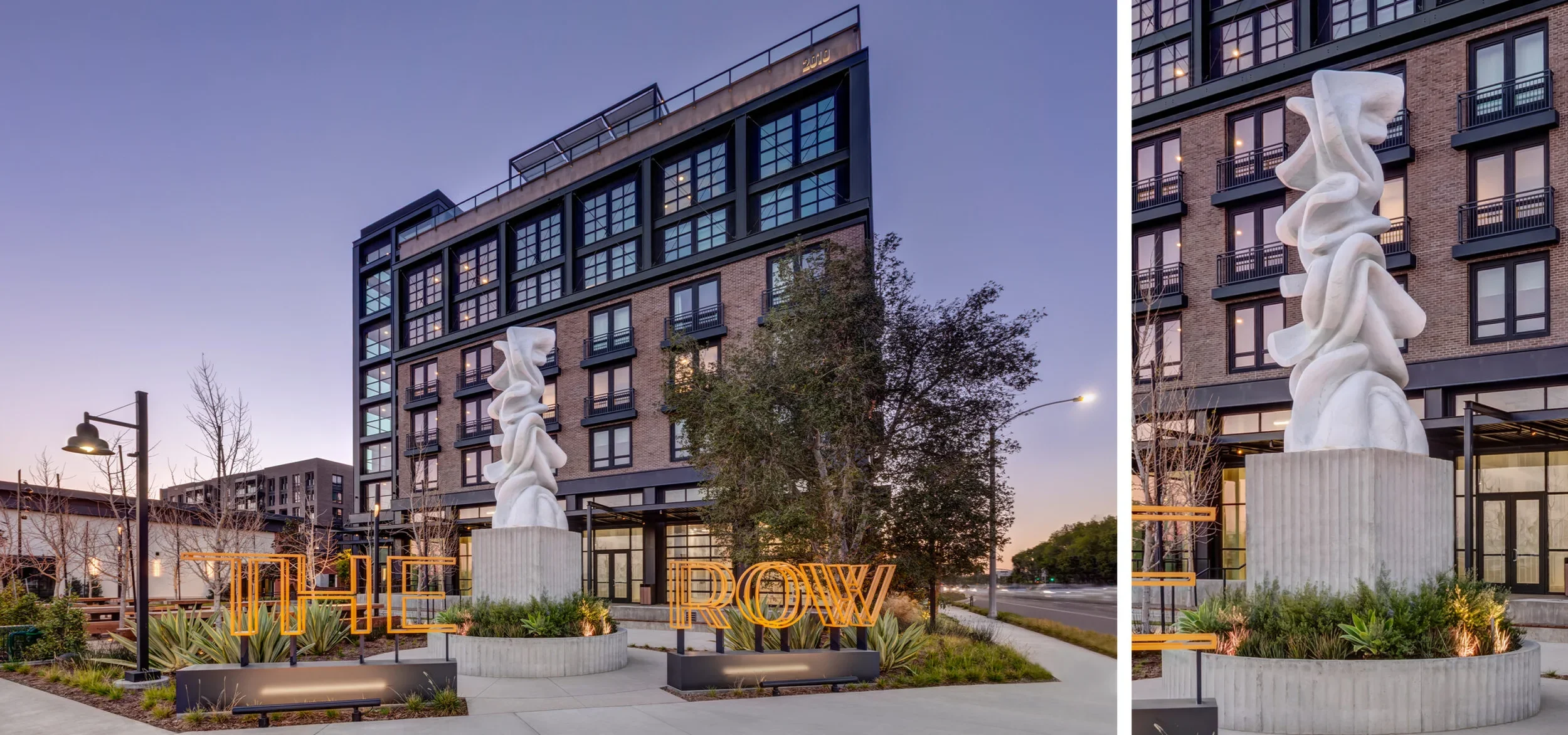 Exterior dusk view of a multifamily brick and metal building with a large sculptural art piece and signage by AO-Architects Orange.