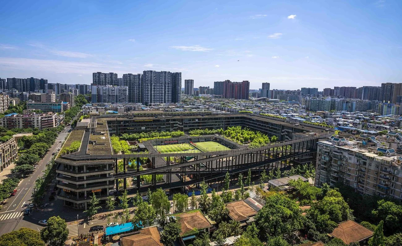 Aerial view of the West Village courtyard megastructure in Chengdu by Liu Jiakun, featuring an elevated perimeter ramp.