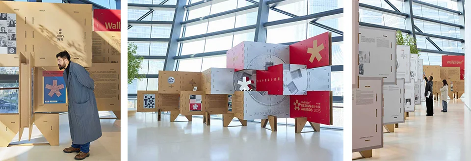Exhibition installation constructed from interlocking modular cardboard display units inside a light-filled glazed hall by Studio 9 Architecture.