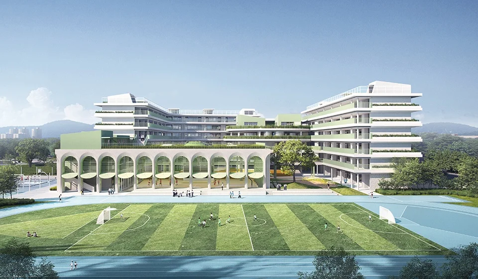 Exterior rendering of an elementary school with an expansive arched colonnade fronting a green sports field.