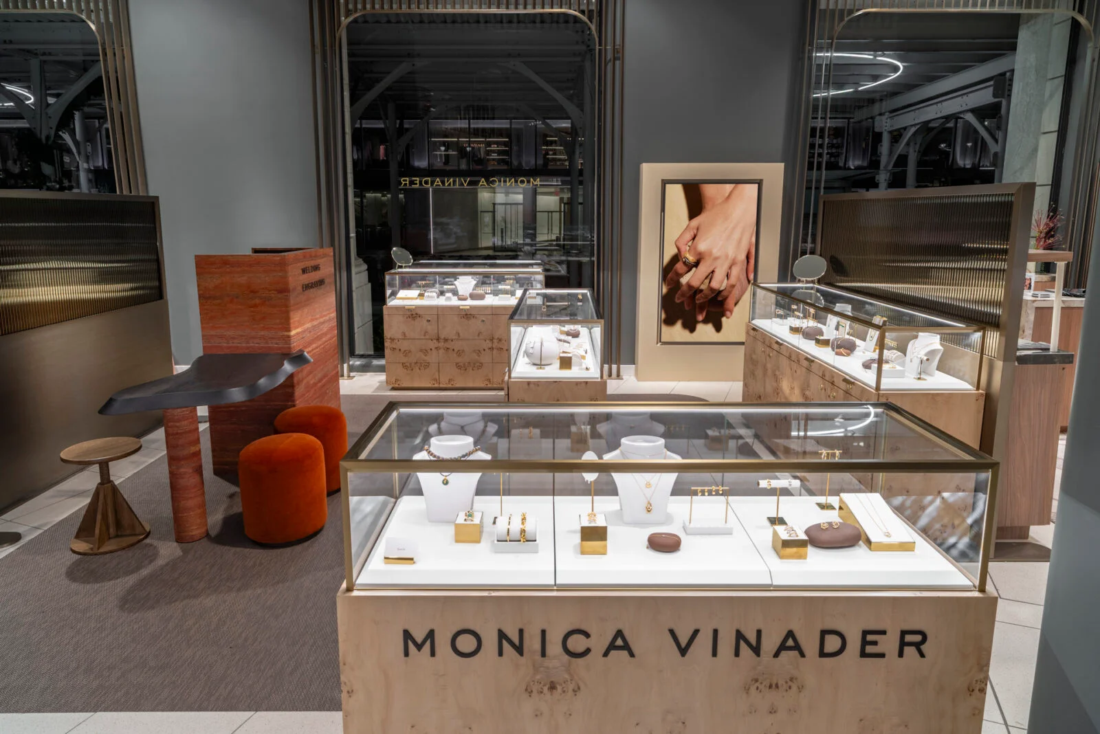 Retail interior featuring custom burl wood and glass jewelry display counters by MG2.
