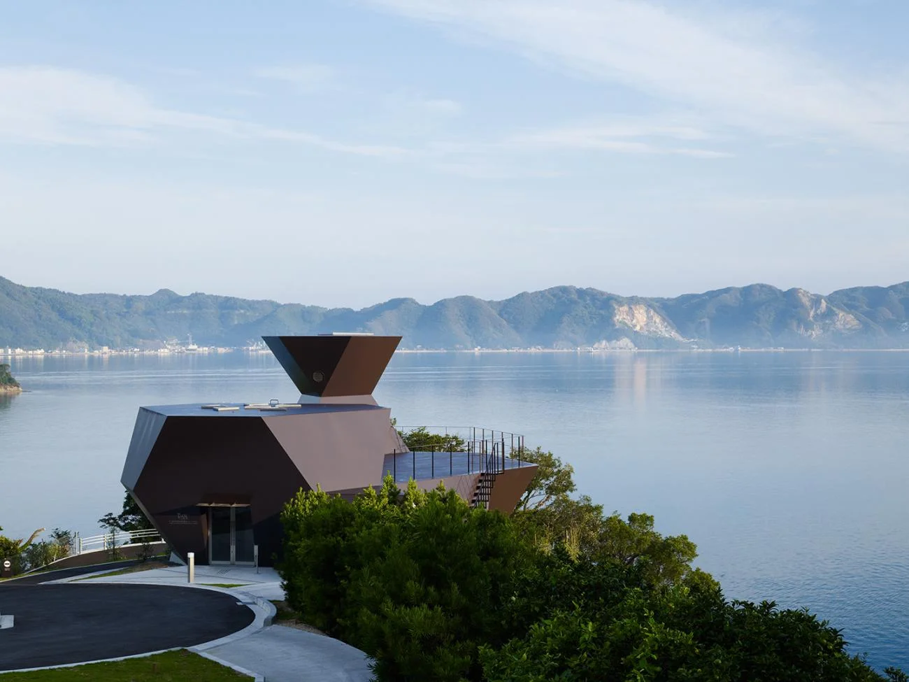 The faceted, dark steel Toyo Ito Museum of Architecture overlooking the sea in Imabari, Japan.