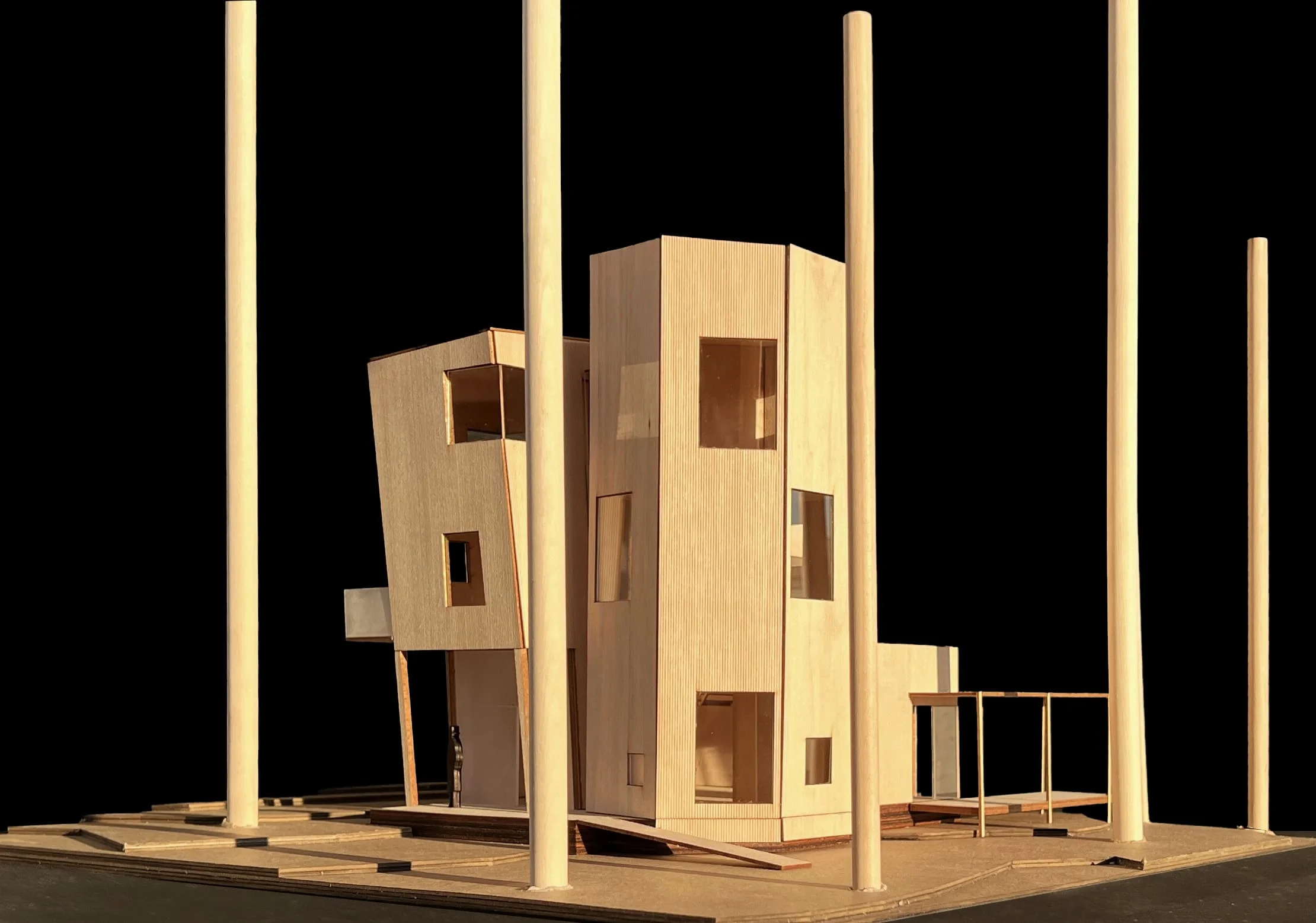 Architectural model of a multi-volume wooden house pierced by tall cylindrical columns by Steven Holl Architects.