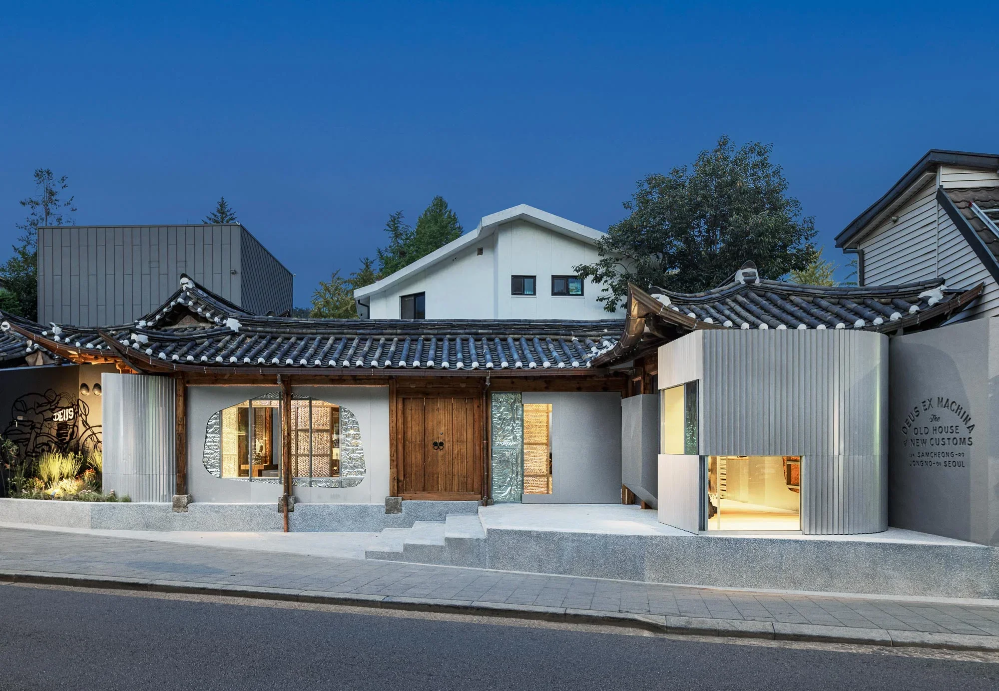 Exterior street view of a hybrid historic Korean Hanok building featuring metallic and textured glass additions by All City and Andrea Caputo.