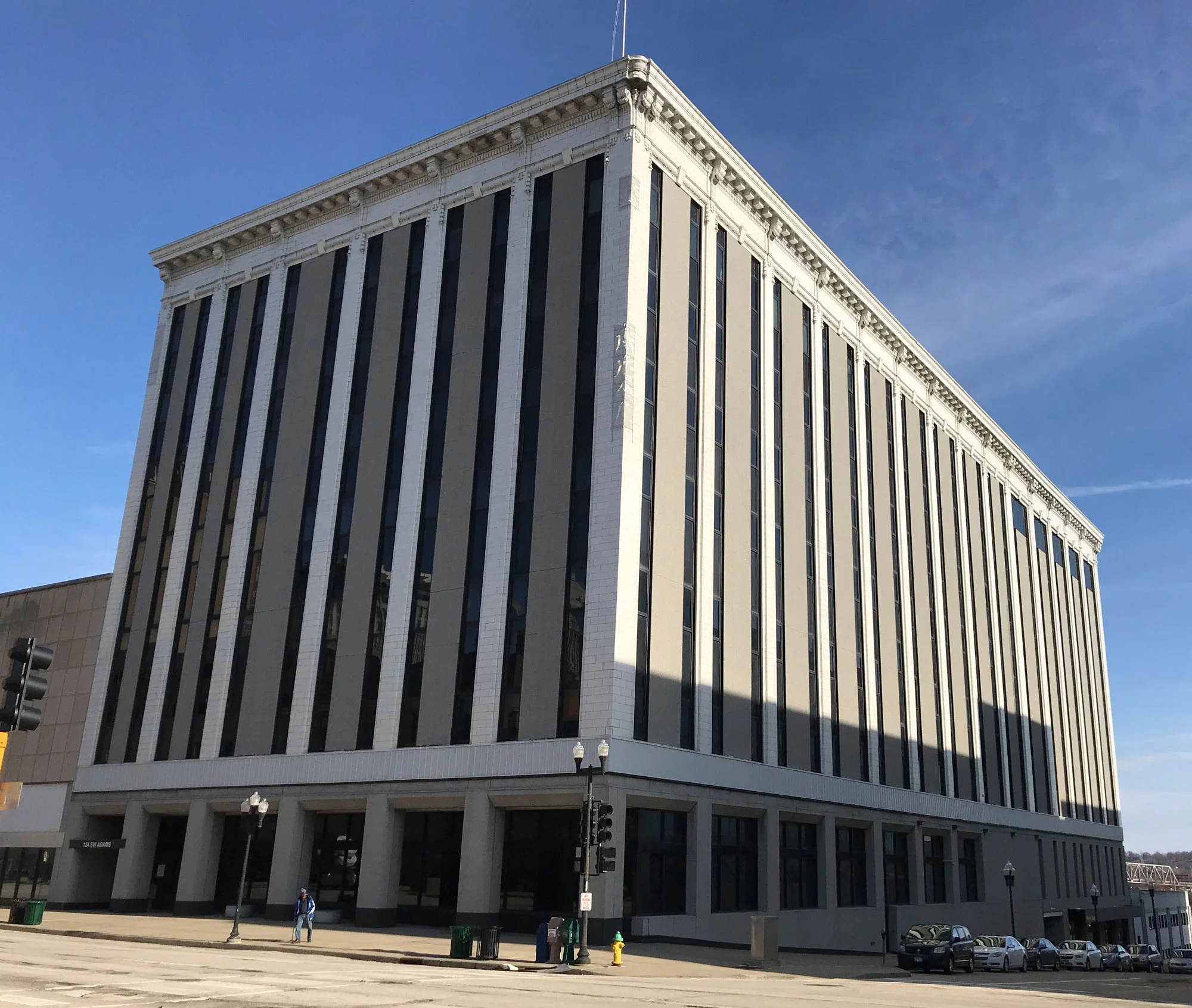 Exterior street view of the OSF HealthCare Ministry Headquarters adaptive reuse project by JLK Architects, showing vertical pilasters and a heavy cornice.
