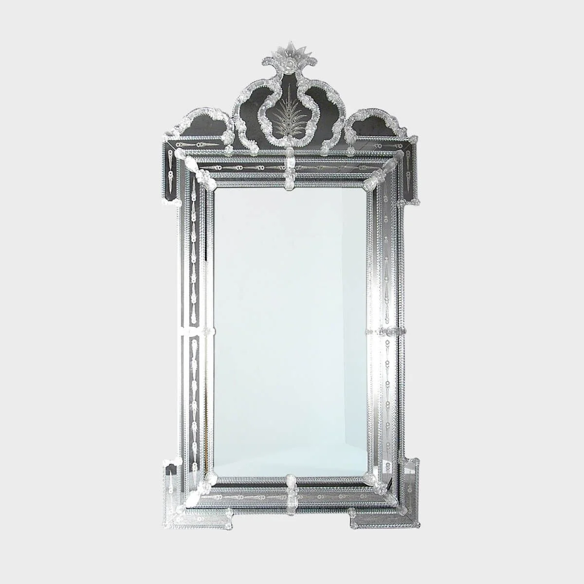 An ornate Venetian-style etched glass mirror with an elaborate crown by Sogni Di Cristallo.