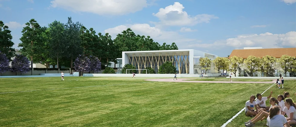 Exterior view of an athletic field with a modern gymnasium featuring a diagrid timber facade facing the pitch, by Parallax Architecture and Planning.