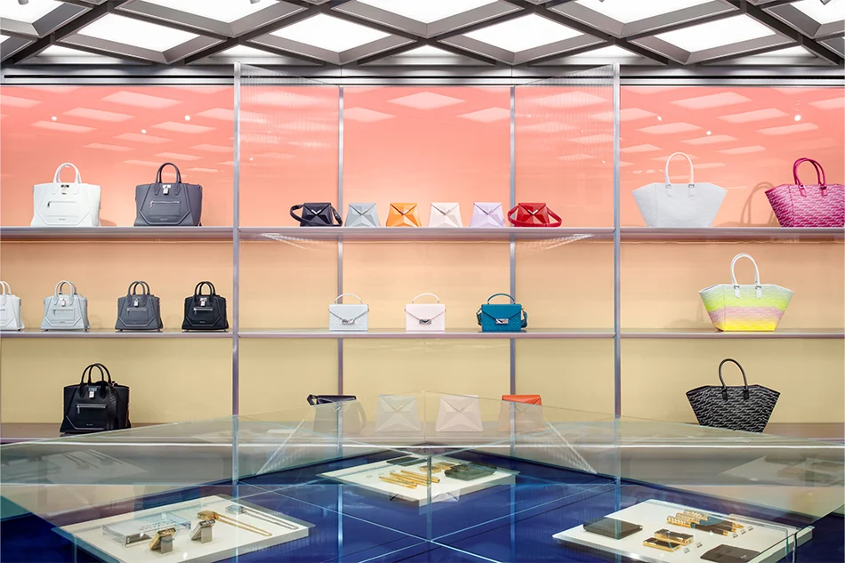 Retail interior display wall with glowing gradient panels and handbags by Sybarite.