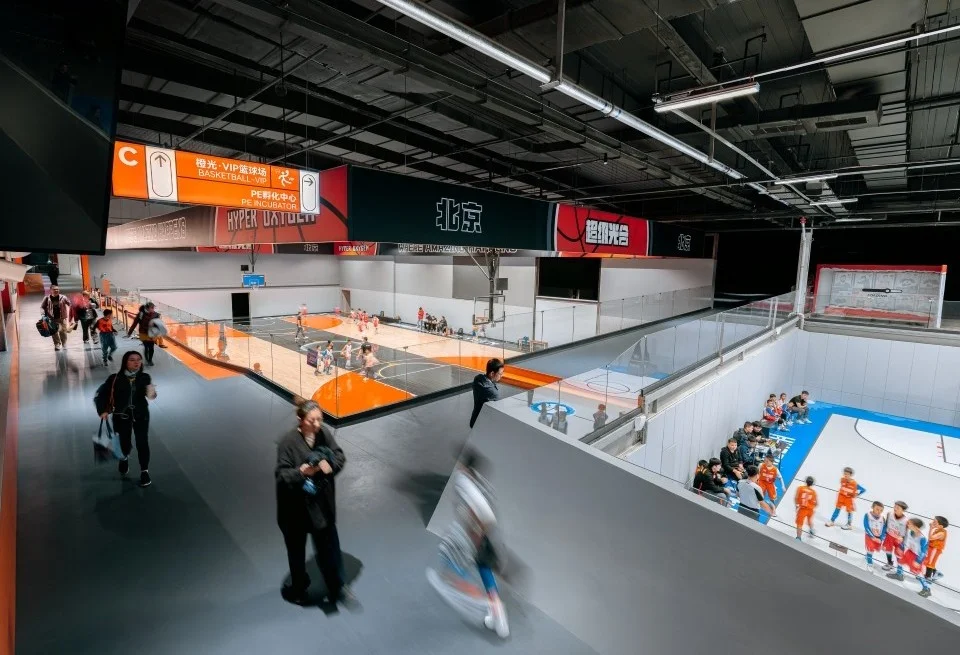 Multi-level indoor basketball facility and circulation concourse by PROJECT普罗建筑 in Beijing.