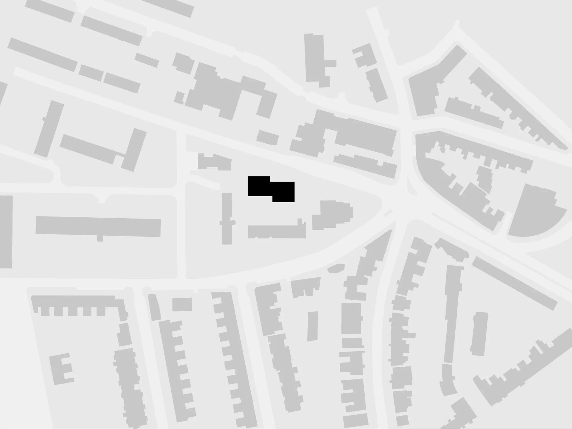 Site plan diagram showing a black highlighted building massing within an urban block context by Al-Jawad Pike.