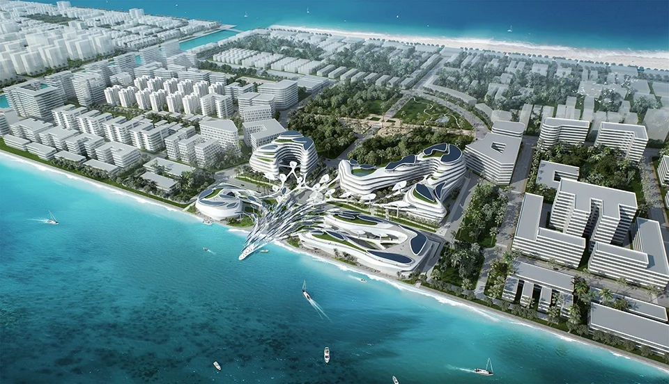 Aerial view of a coastal master plan with organic, fluid-form architecture along a turquoise sea by CAA.