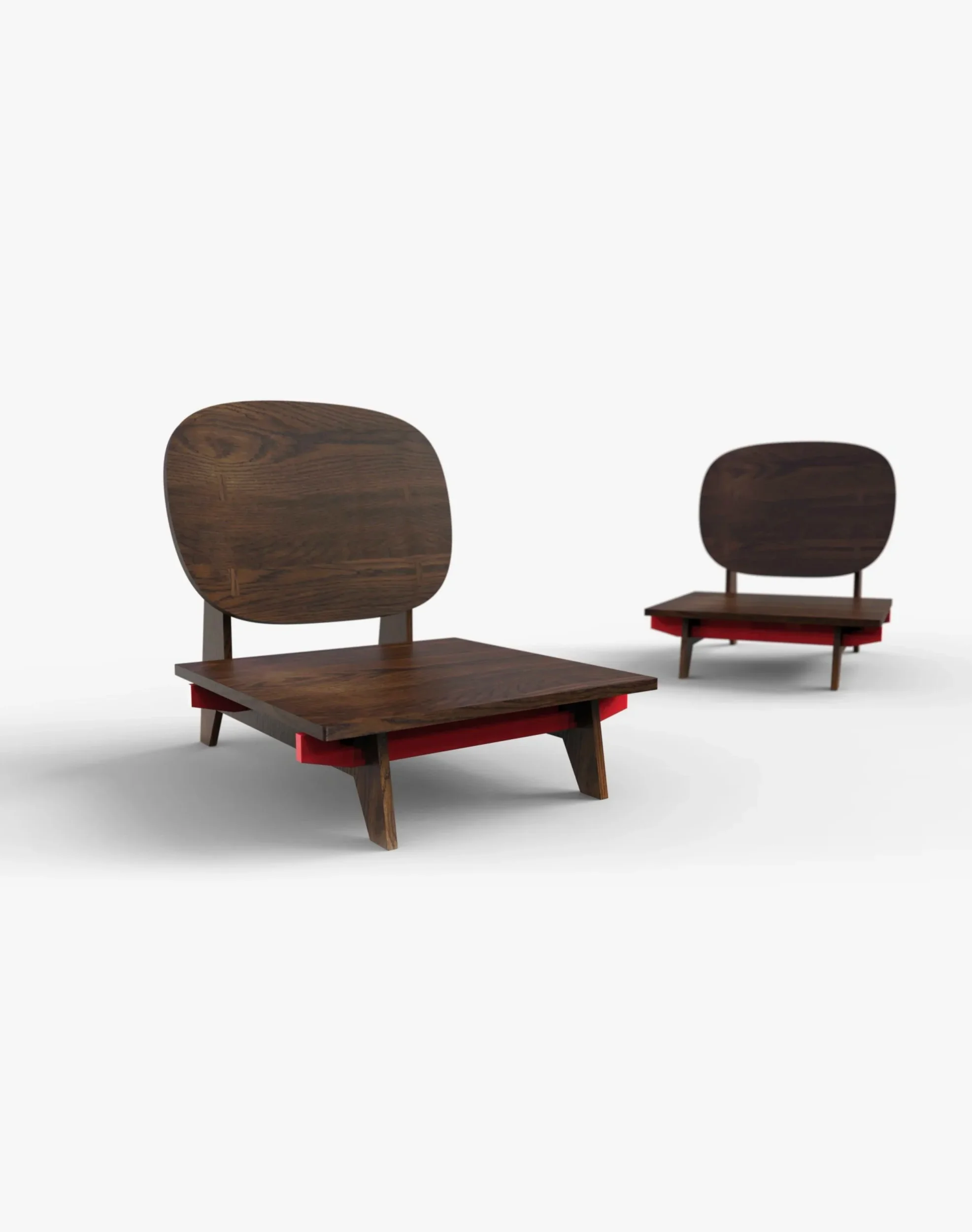 Low dark-wood lounge chairs with red structural elements from the Yayoi Collection by Birsel + Seck.
