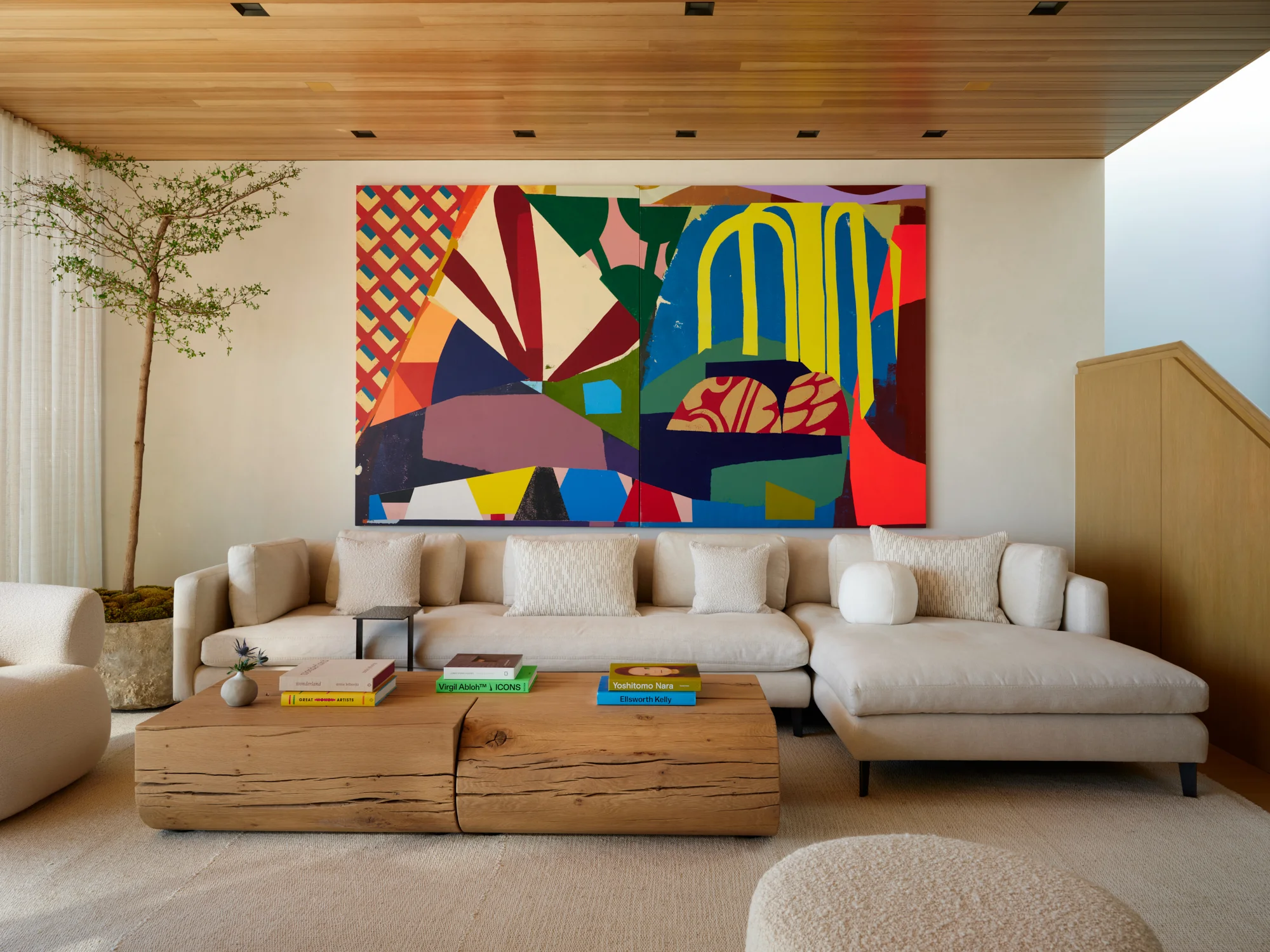 Laney LA - HF Residence living room with a large abstract painting, sectional sofa, and natural timber coffee tables.