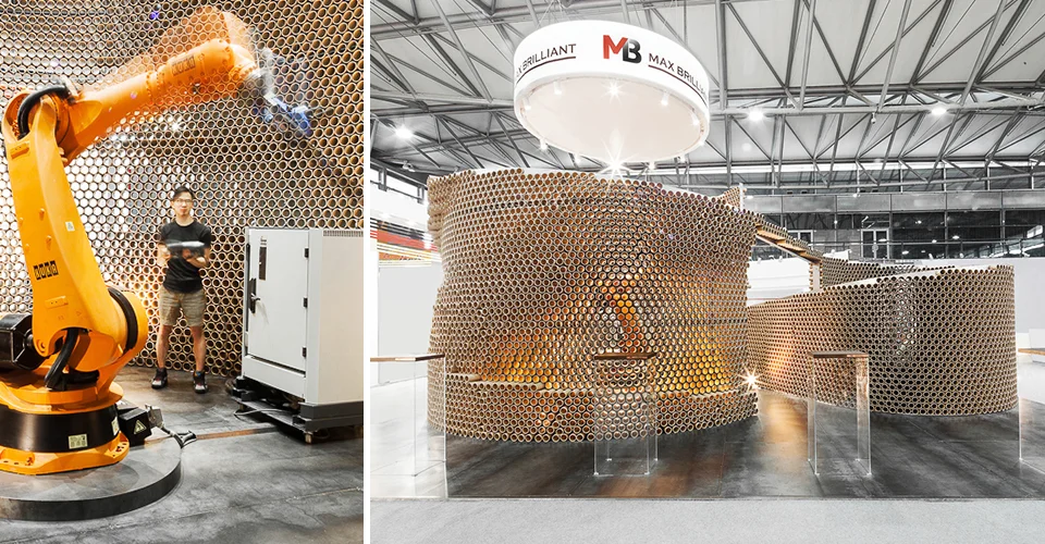 Exhibition pavilion built from stacked cardboard tubes with an industrial robotic arm inside by dongqi Design.