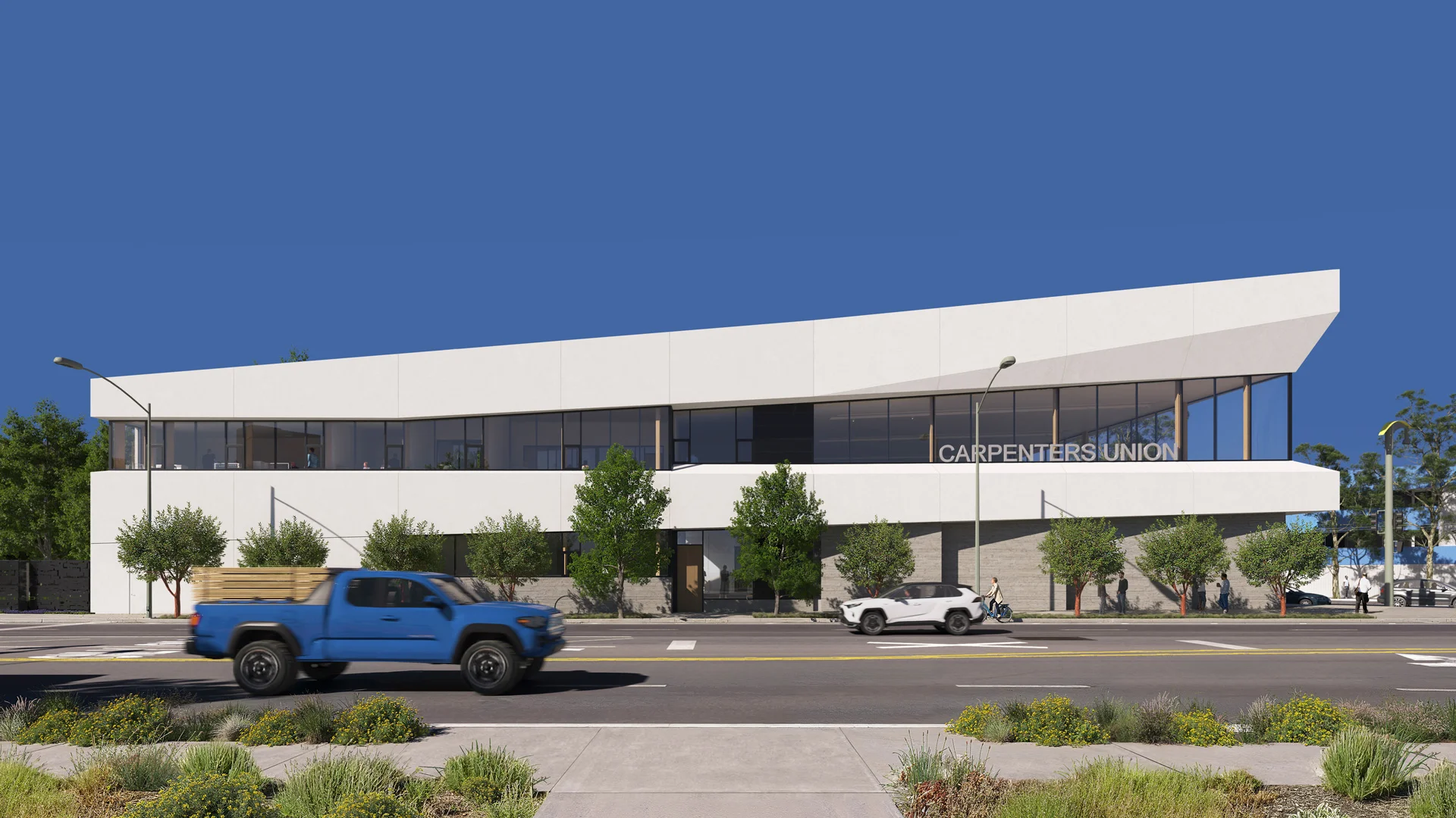 Exterior facade of a low-rise Carpenters Union building featuring white upper massing, continuous ribbon glazing, and a textured ground floor by Mithun.