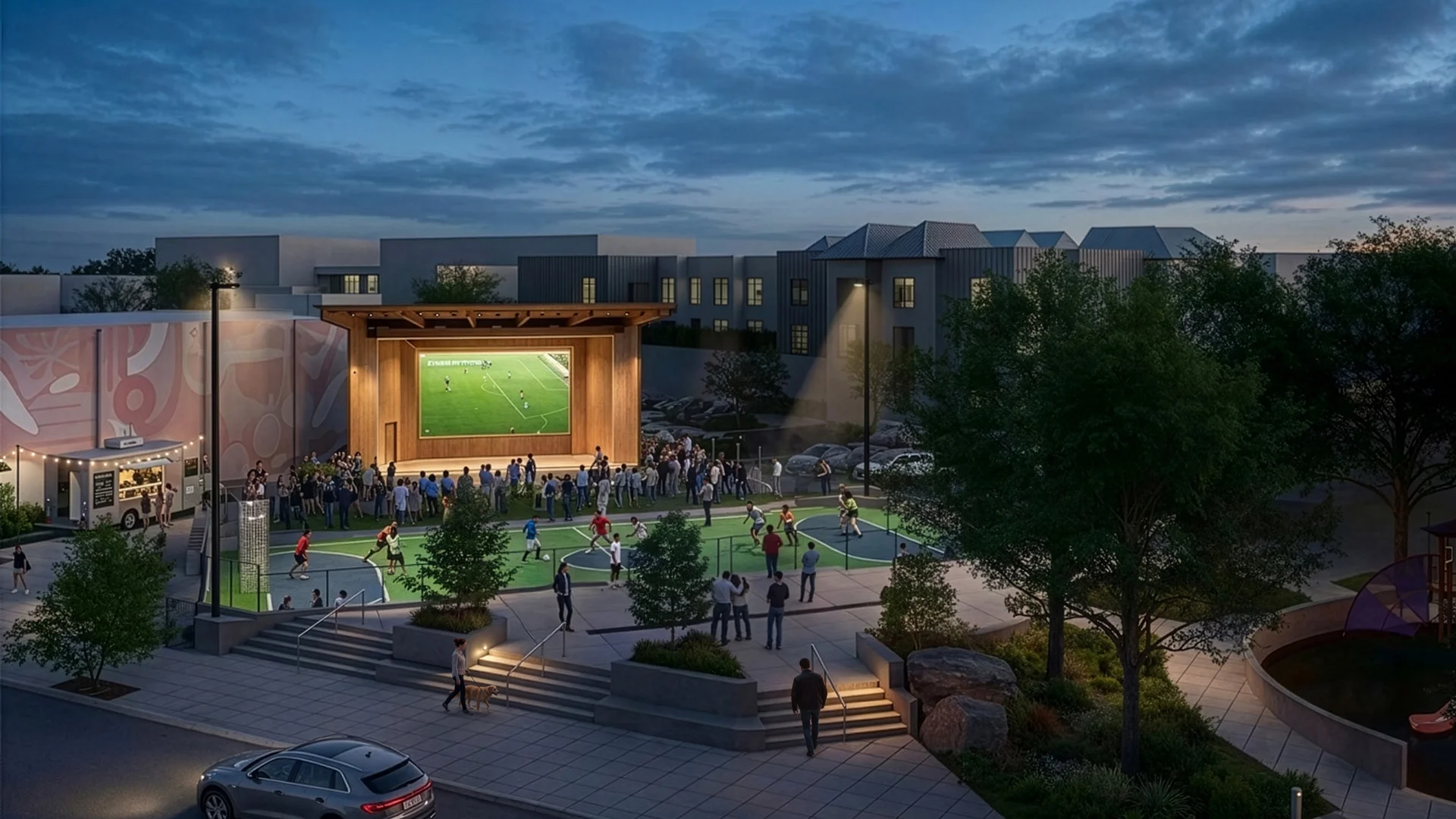 Aerial twilight rendering of Legacy Square Stage by Mithun featuring an outdoor sports court and large video screen.