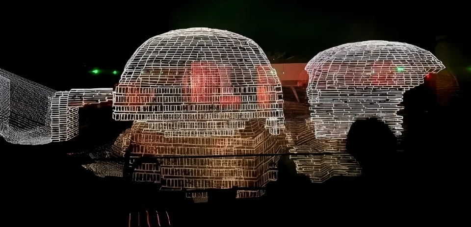Nighttime illumination of ancient brick tomb protection structure featuring wireframe light projection by 清城睿现公司 in Beijing.