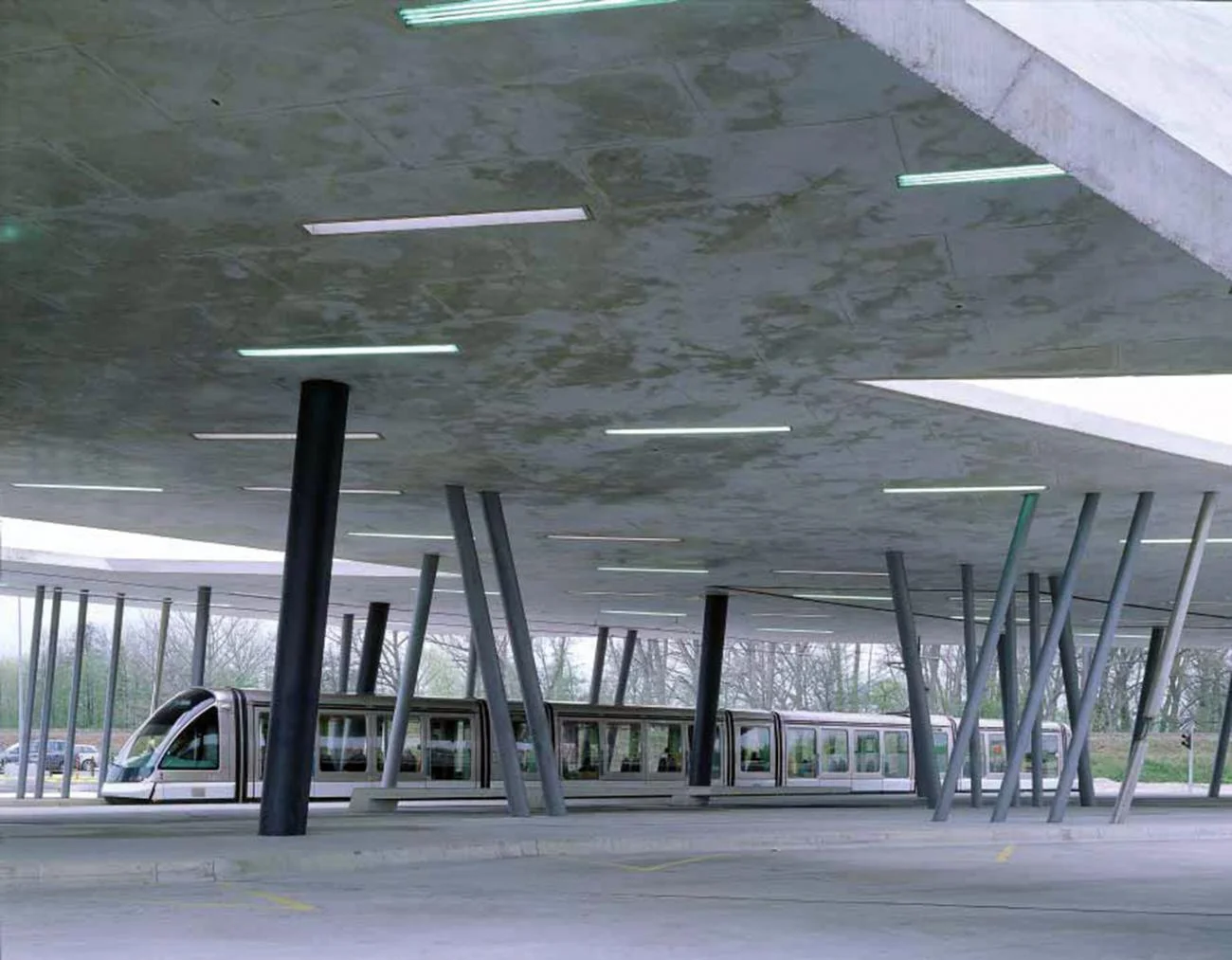 Concrete canopy with angled columns sheltering a tram at Hoenheim North Terminus by Zaha Hadid.