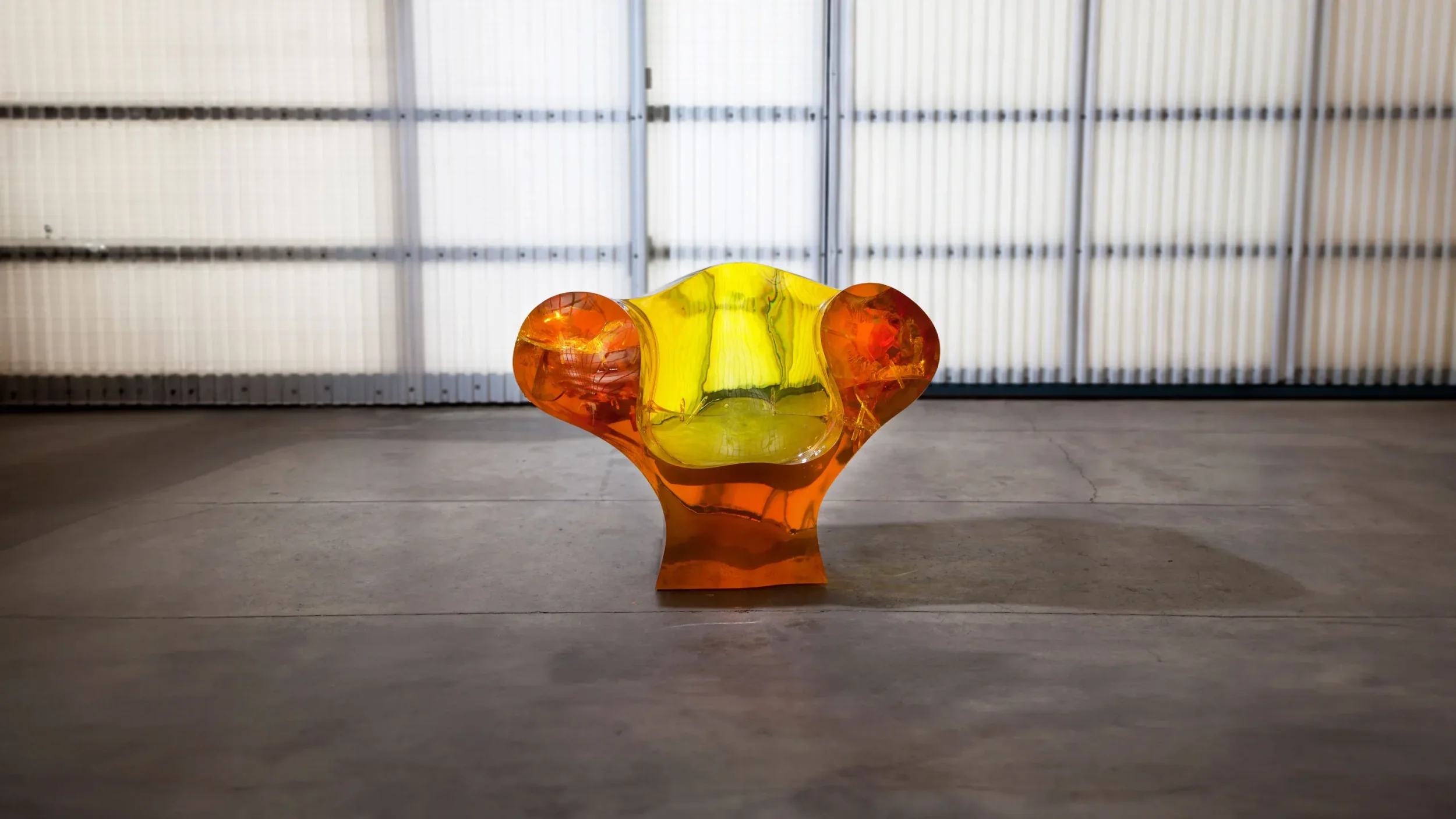 Cast translucent orange and yellow resin sculptural lounge chair by Ron Arad Studio.