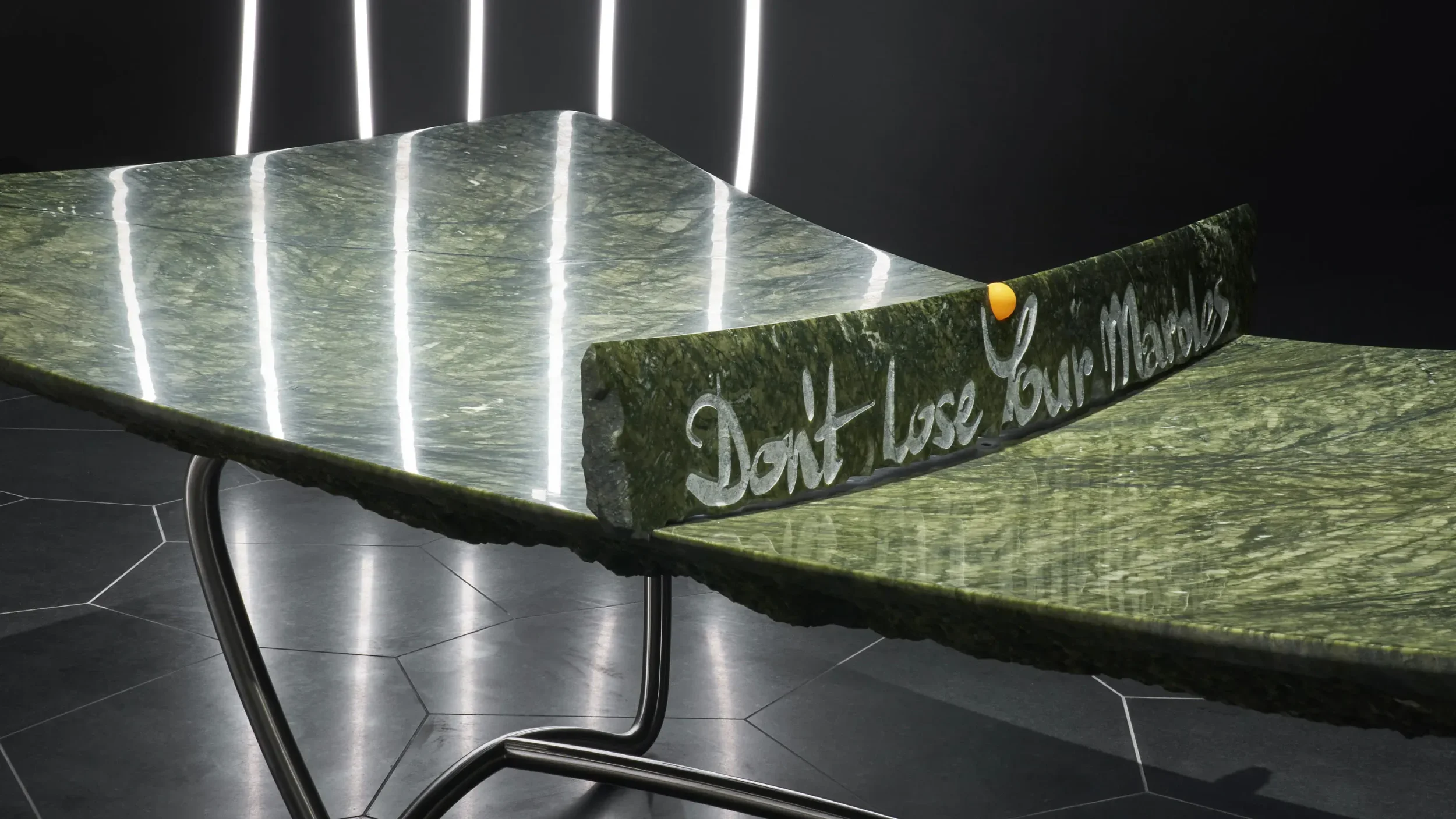 Green marble ping pong table with raw edges and steel legs by Ron Arad Studio.
