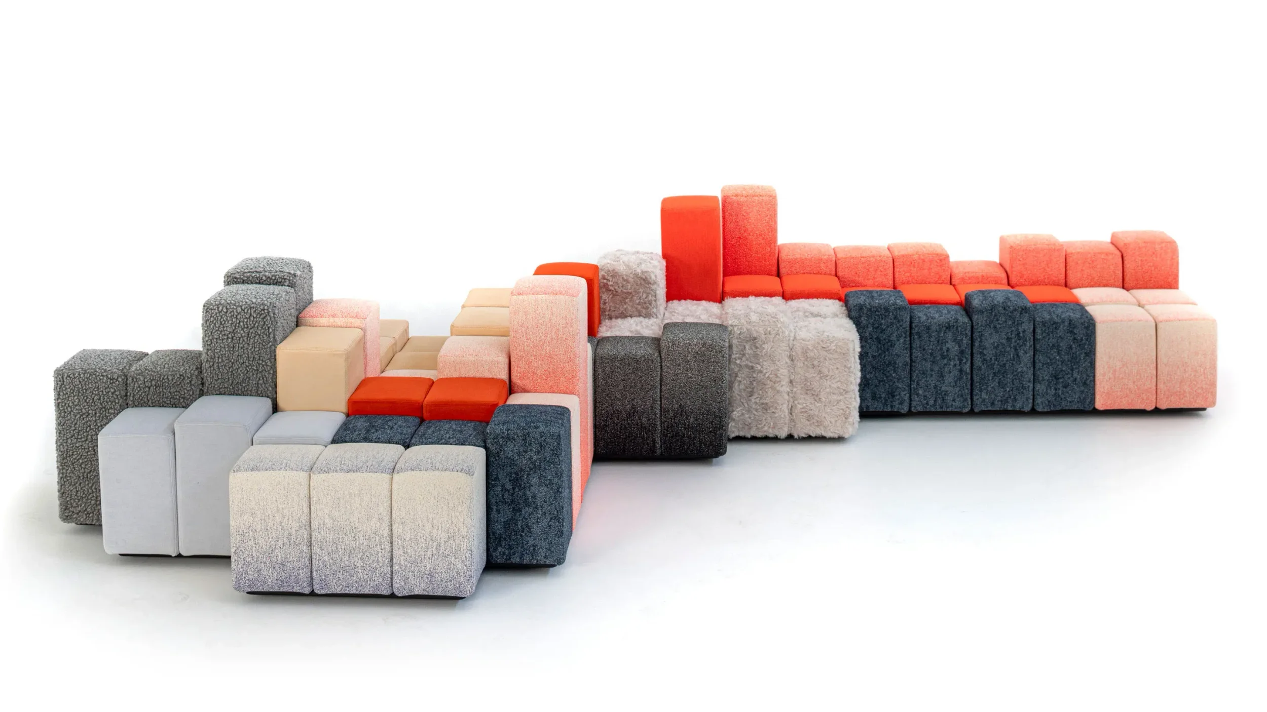 Modular upholstered seating system composed of multicolored and textured block units by Ron Arad Studio.
