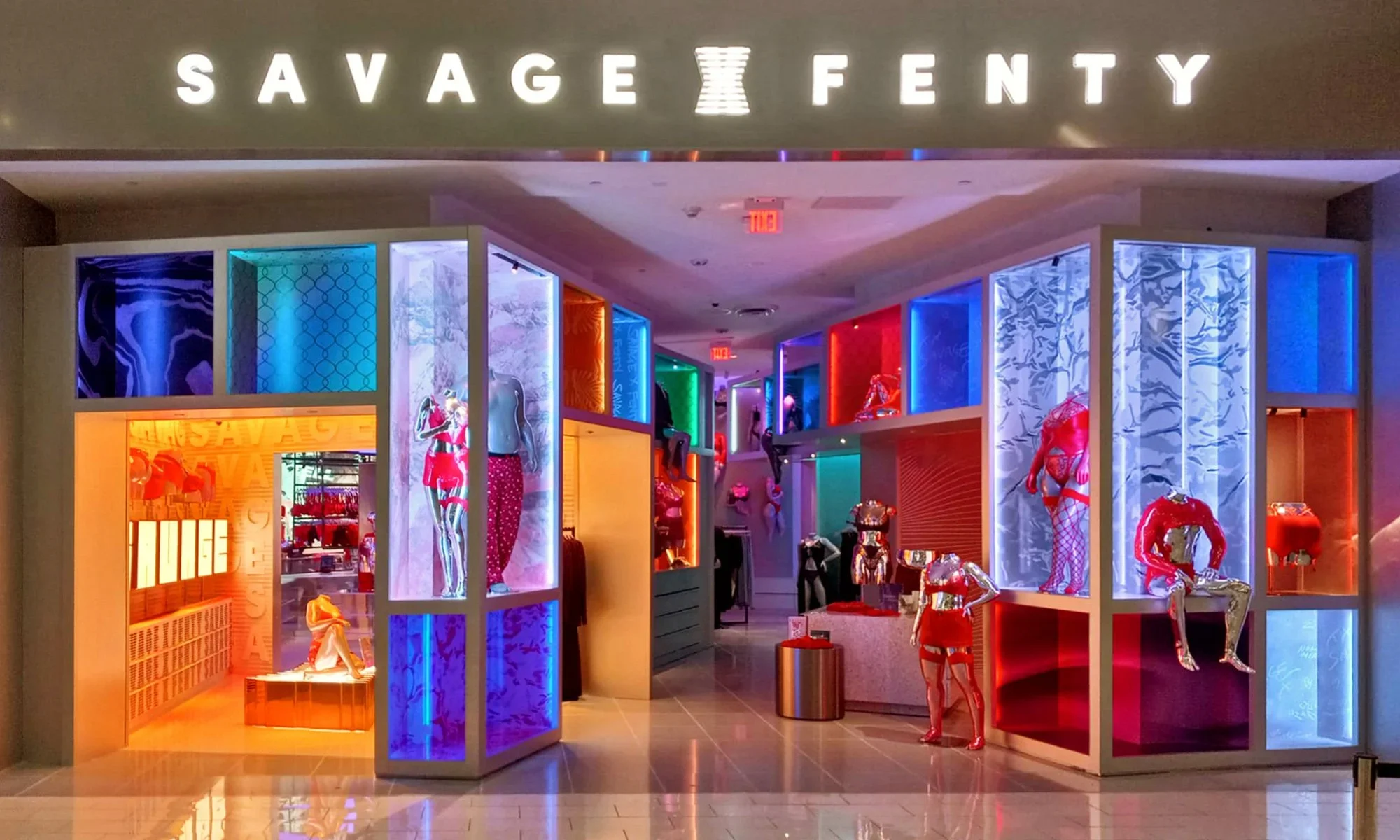 Storefront and illuminated display bays of Savage X Fenty retail store by O'Neil Langan Architects.