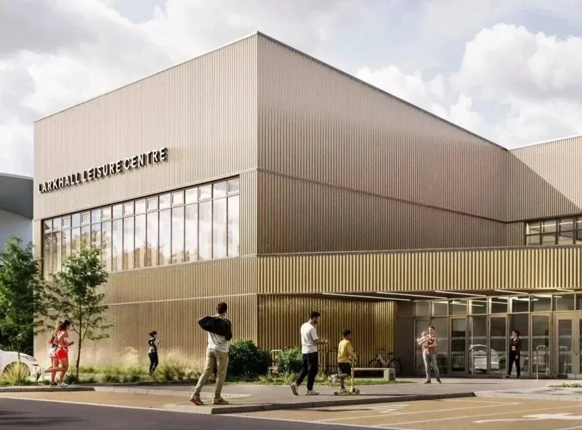 Exterior facade of Larkhall Leisure Centre by Holmes Miller featuring corrugated metal cladding and large strip glazing.