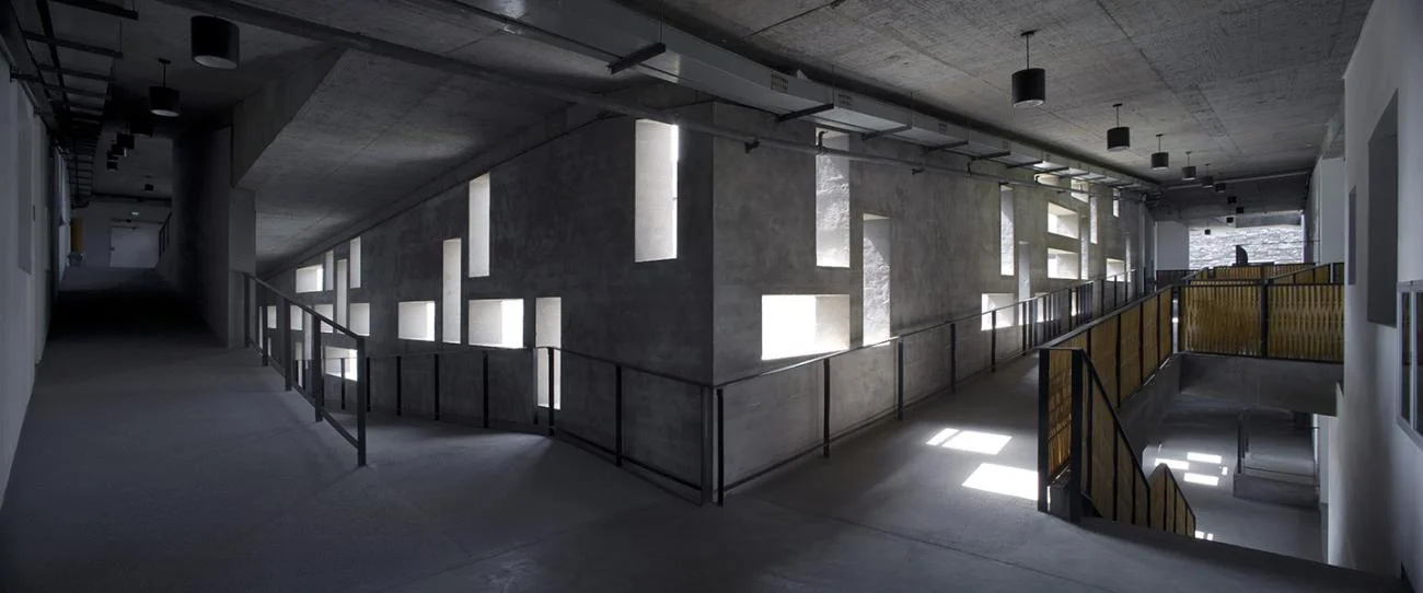 Concrete ramps with staggered rectangular window openings at Xiangshan Campus by Wang Shu.