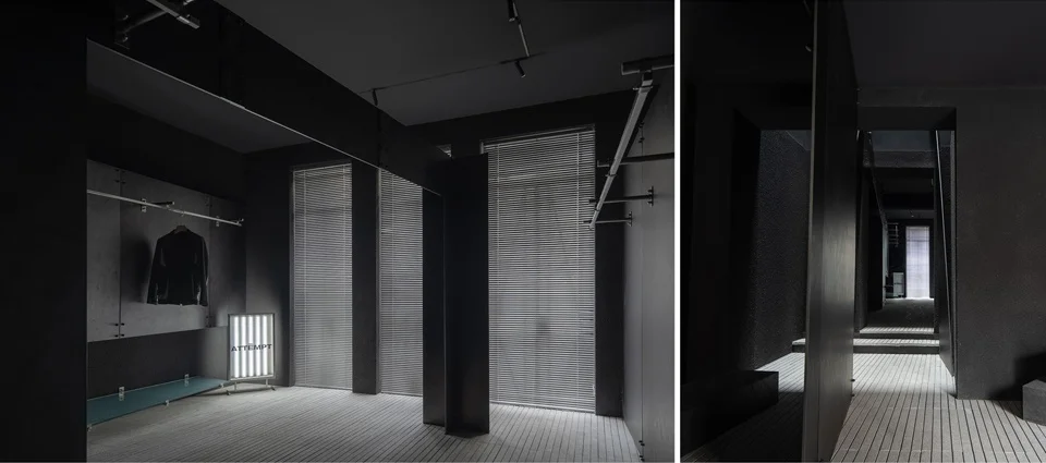 Monochromatic dark interior of ATTEMPT flagship store in Shanghai by SLT with black walls, slatted blinds, and minimalist garment racks.